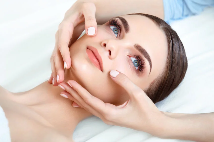 Client enjoying a relaxing face lifting massage at SI Glam Glow in Staten Island
