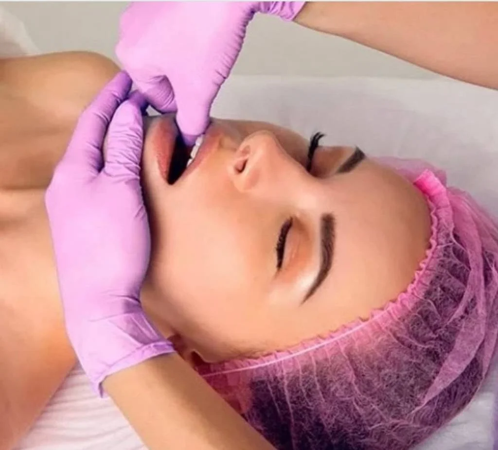 Licensed esthetician performing a face lifting massage at SI Glam Glow in Staten Island