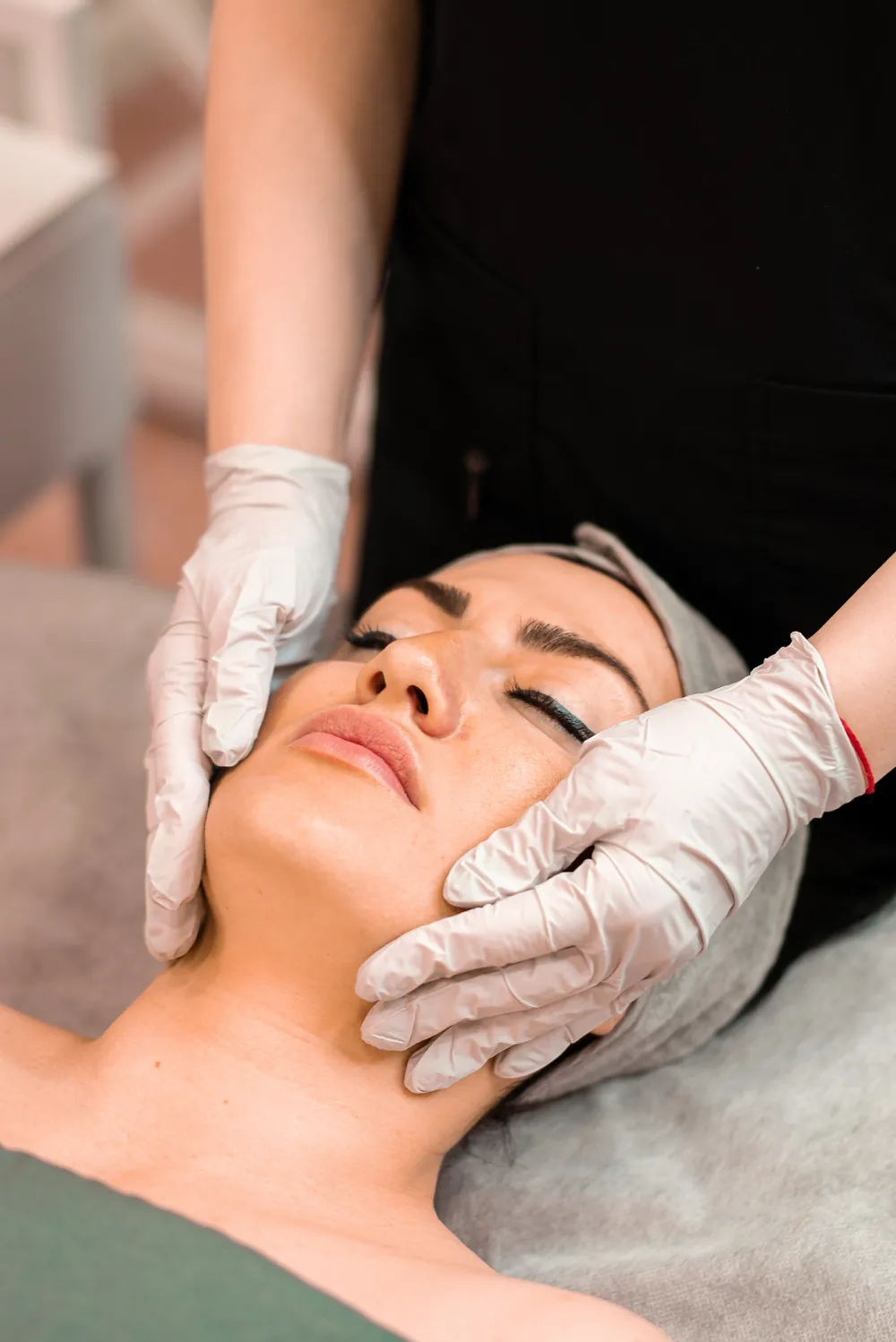 Licensed esthetician performing a Microcurrent Staten Island facial at SI Glam Glow