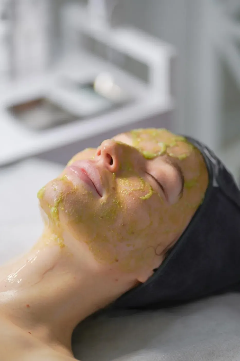 Client relaxing with a nourishing facial mask during a skin care treatment at SI Glam Glow in Staten Island