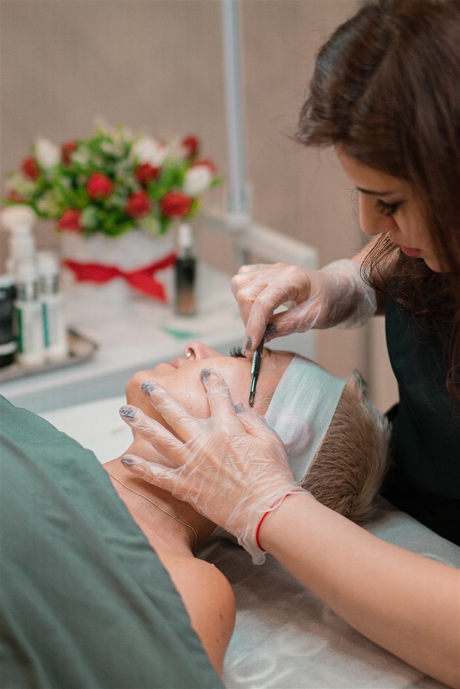 Licensed esthetician performing a Dermaplaning Facial at SI Glam Glow