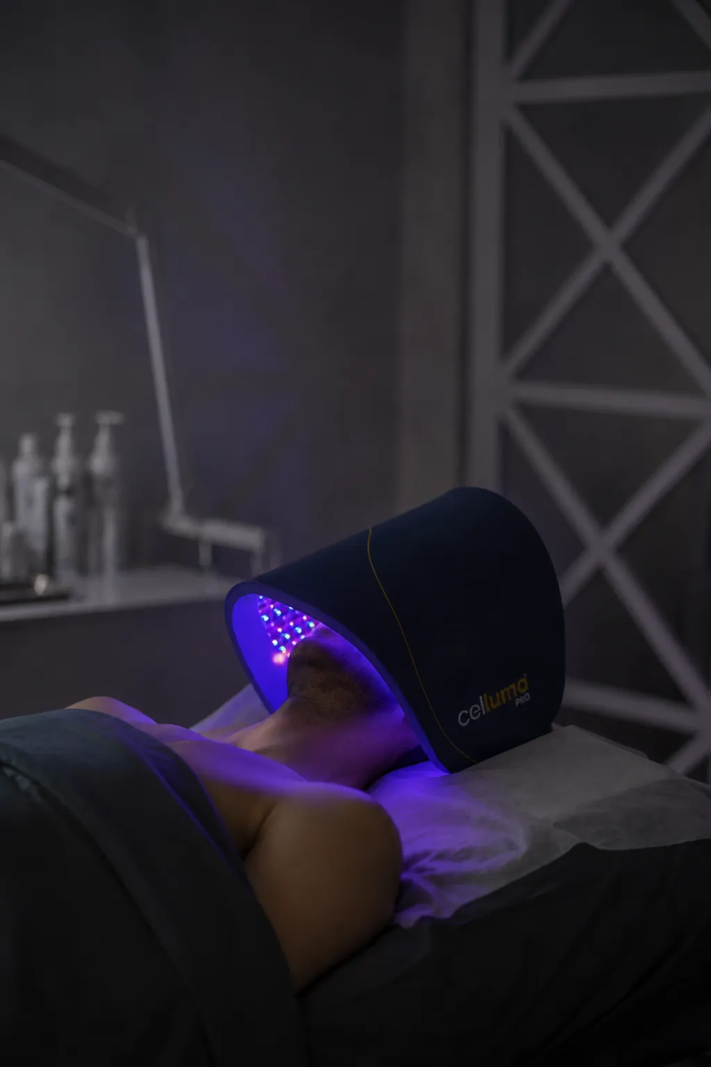 Client finishing a Gentleman's Facial with Celluma LED light therapy at SI Glam Glow